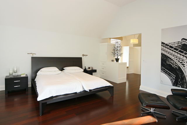 Example of a large transitional master medium tone wood floor bedroom design in Toronto with white walls