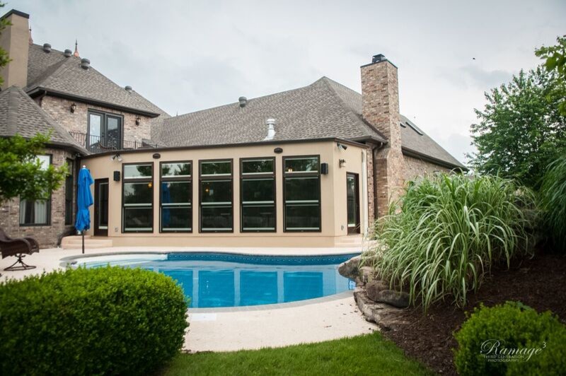 Example of a mid-sized transitional backyard stamped concrete and custom-shaped lap water slide design