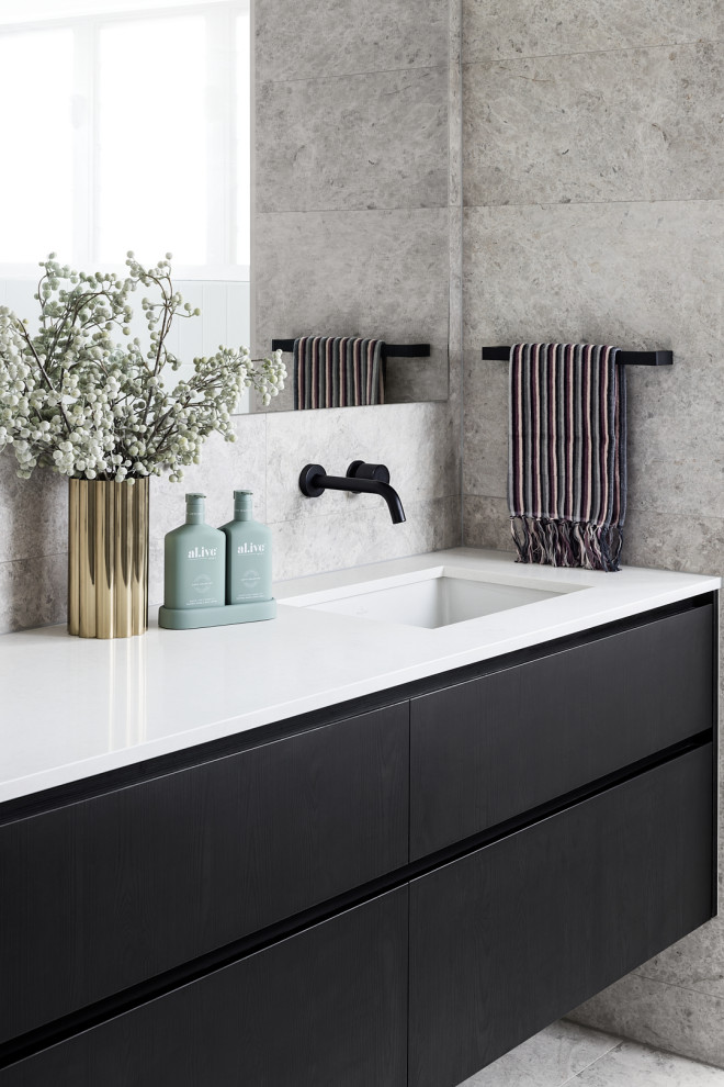 Design ideas for a mid-sized midcentury bathroom in Brisbane with flat-panel cabinets, dark wood cabinets, gray tile, porcelain tile, grey walls, an undermount sink, engineered quartz benchtops, grey floor, white benchtops, a single vanity and a floating vanity.