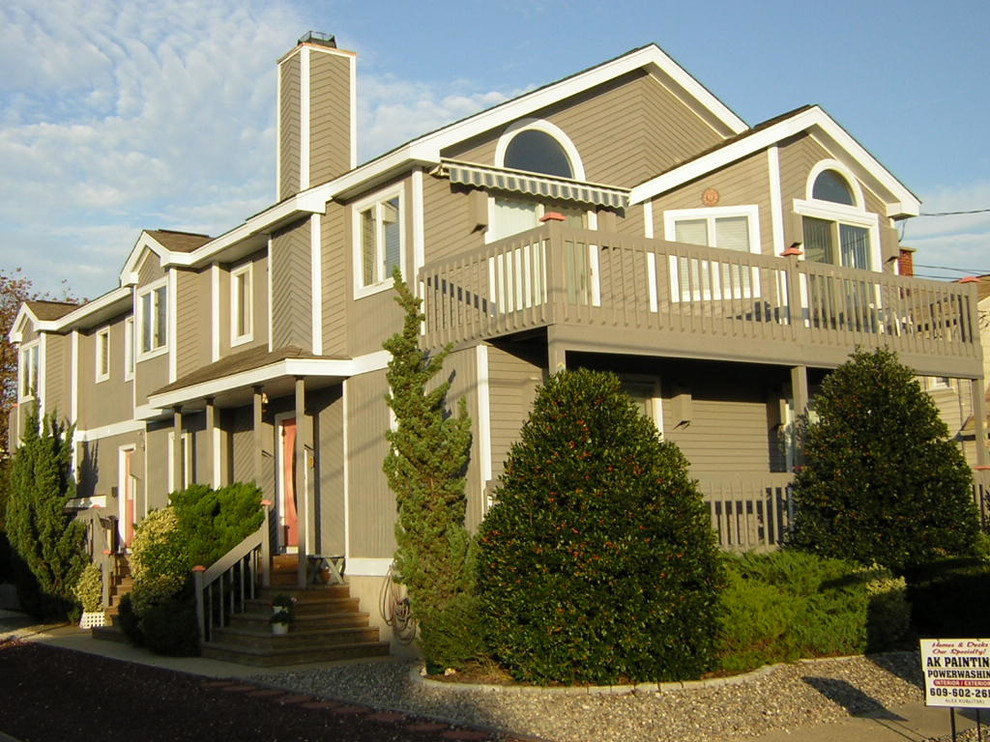 This is an example of a large beach style two-storey brown exterior in Philadelphia with wood siding.