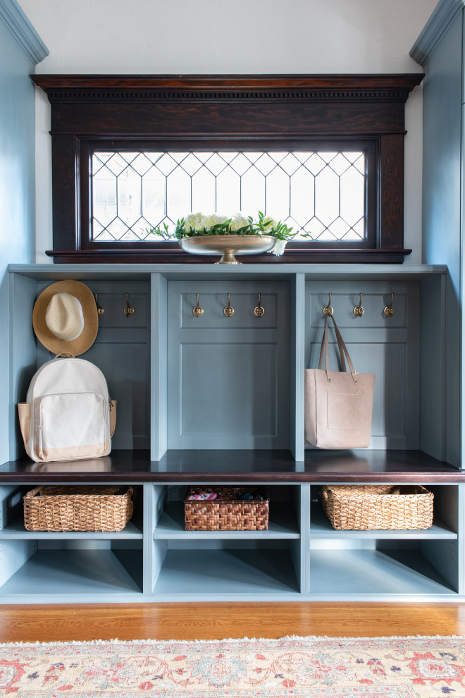 Inspiration for a small timeless light wood floor and brown floor single front door remodel in Seattle with white walls and a brown front door