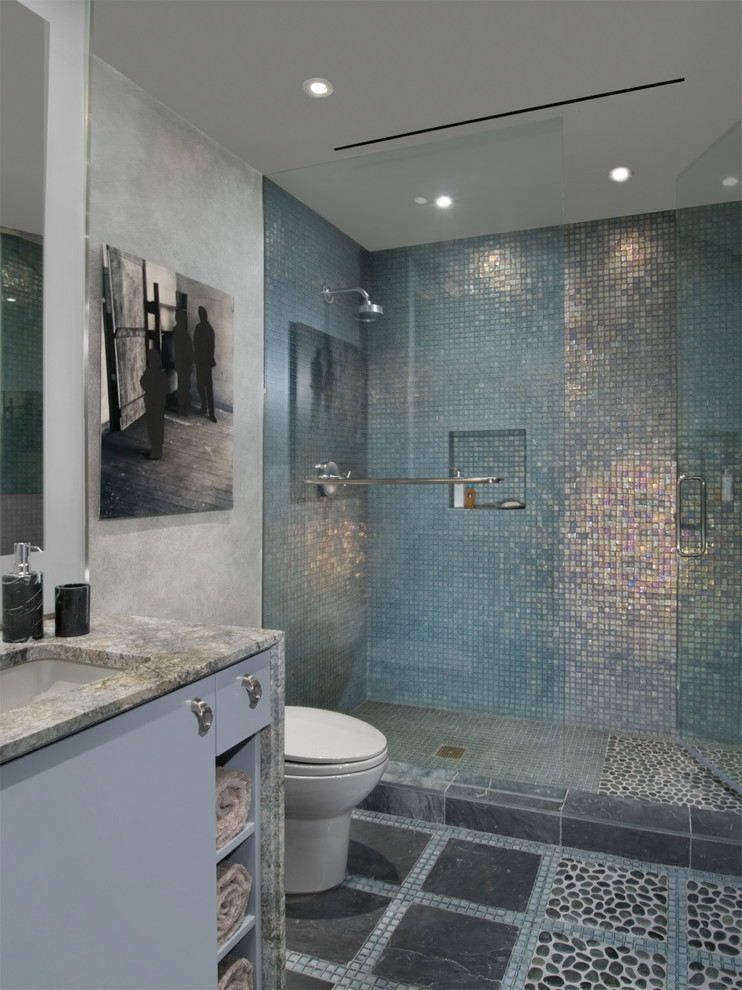 This is an example of a large contemporary 3/4 bathroom in Chicago with flat-panel cabinets, grey cabinets, an alcove shower, multi-coloured tile, metal tile, grey walls, pebble tile floors, an undermount sink, granite benchtops, multi-coloured floor and a hinged shower door.