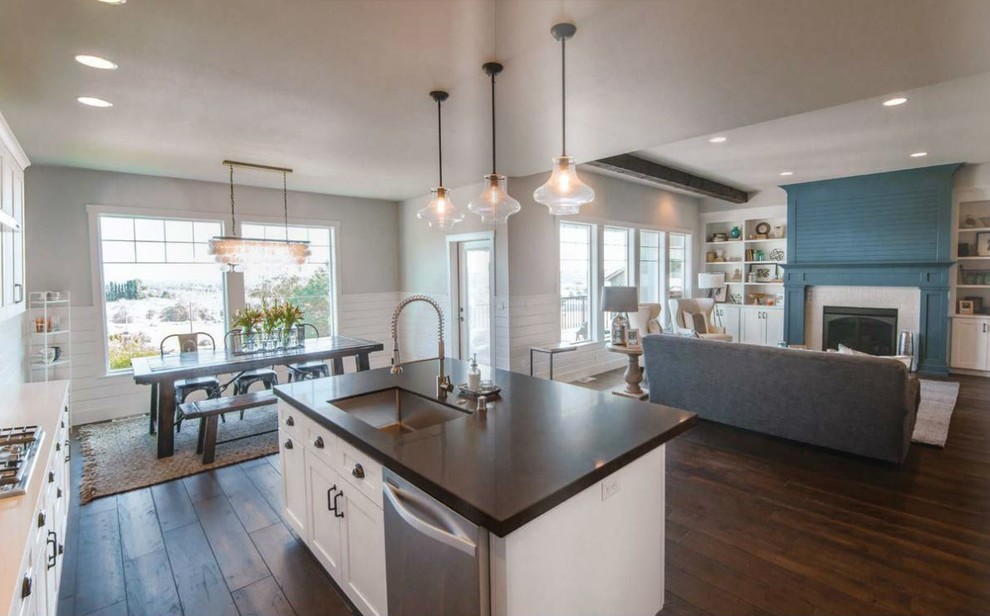 Photo of a modern open plan kitchen in Seattle with stainless steel appliances, medium hardwood floors and with island.