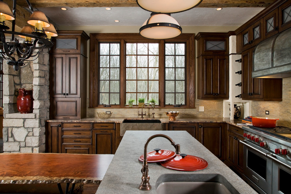Photo of a country eat-in kitchen in Chicago with a farmhouse sink, dark wood cabinets, beige splashback, stainless steel appliances and with island.