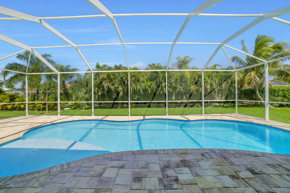 Mid-sized transitional backyard brick and kidney-shaped pool photo