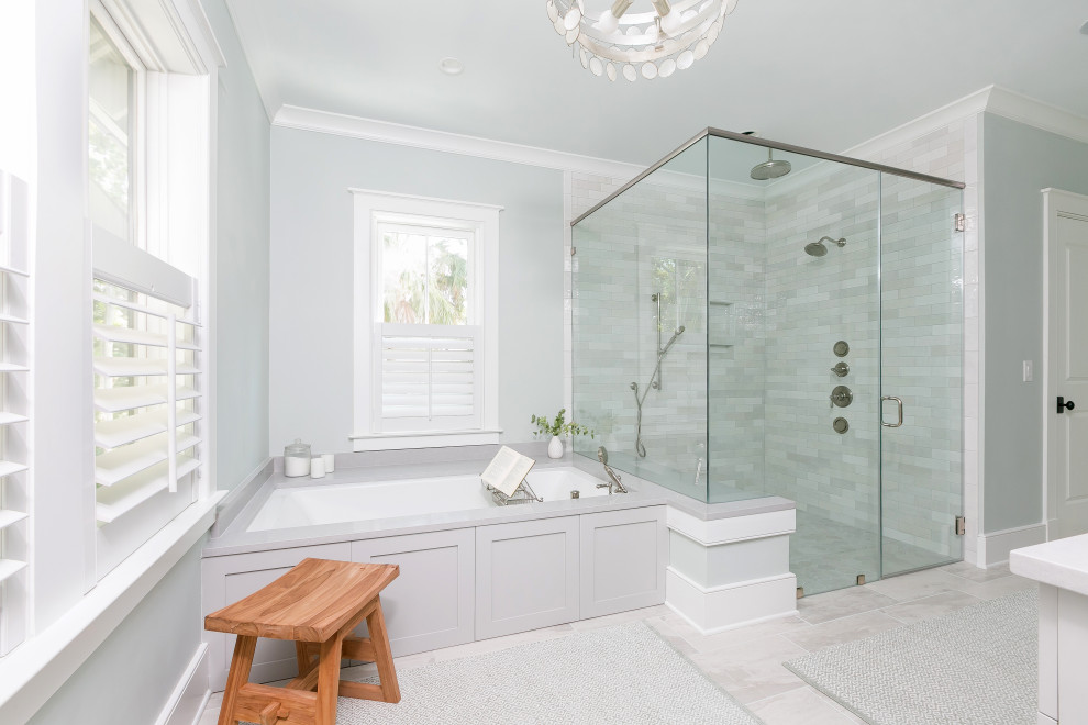 Design ideas for a large transitional master bathroom in Charleston with an undermount tub, a curbless shower, gray tile, subway tile, porcelain floors, engineered quartz benchtops, a hinged shower door, a shower seat, a niche, a built-in vanity, grey walls, grey floor and white benchtops.