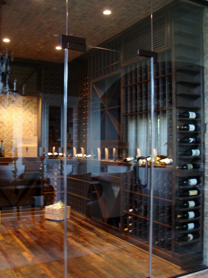 Photo of a mid-sized contemporary wine cellar in Orange County with medium hardwood floors and display racks.