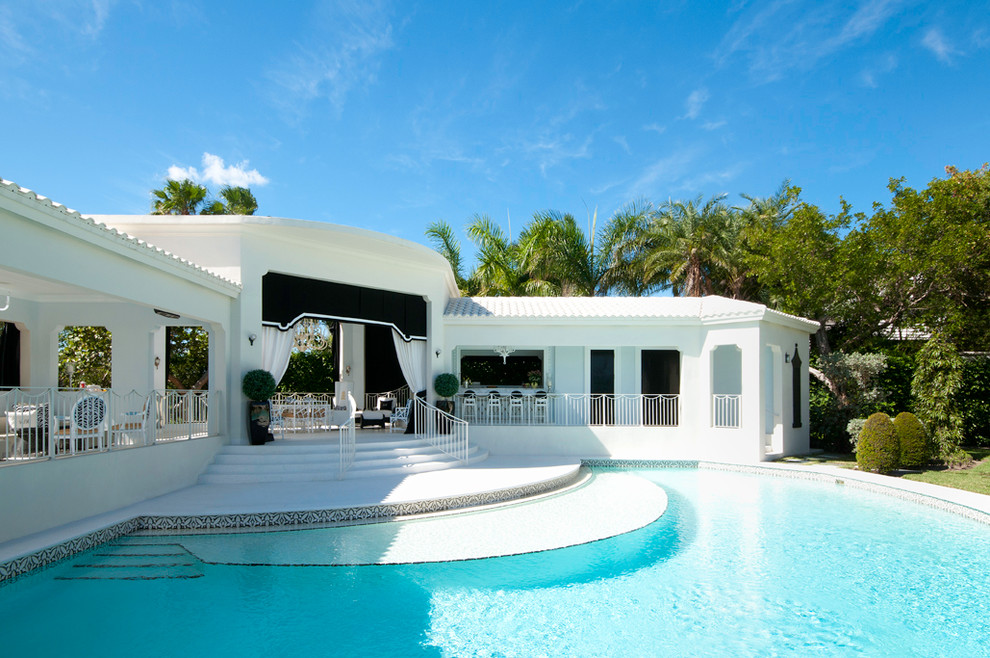 Design ideas for a transitional courtyard round pool in Miami with a pool house.