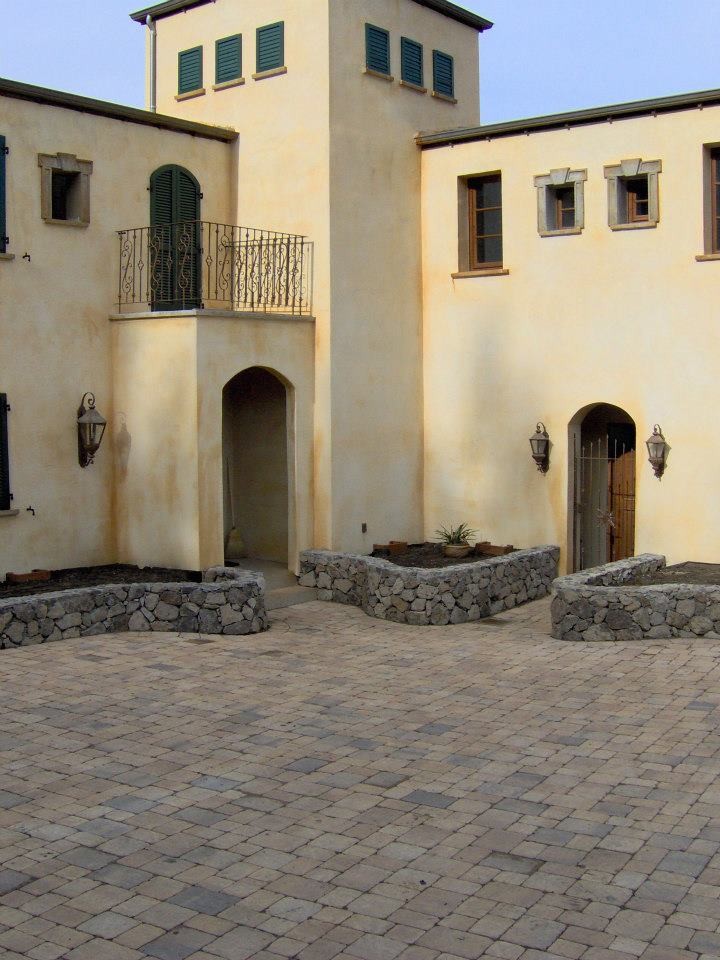 Photo of a large mediterranean courtyard driveway in San Francisco with concrete pavers.