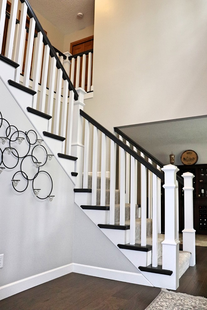 Transitional carpeted l-shaped wood railing staircase photo in Cedar Rapids with carpeted risers