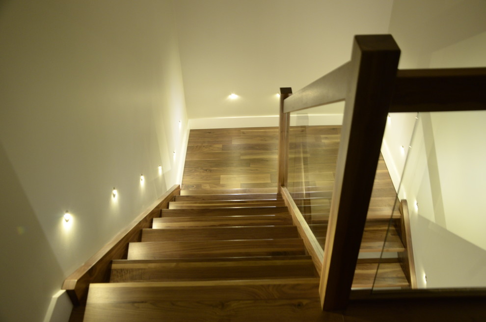 Mid-sized minimalist wooden l-shaped open and glass railing staircase photo