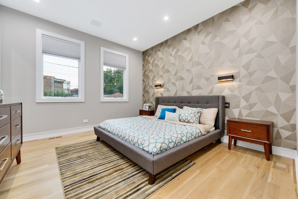 Contemporary bedroom in Chicago with grey walls, light hardwood floors and beige floor.