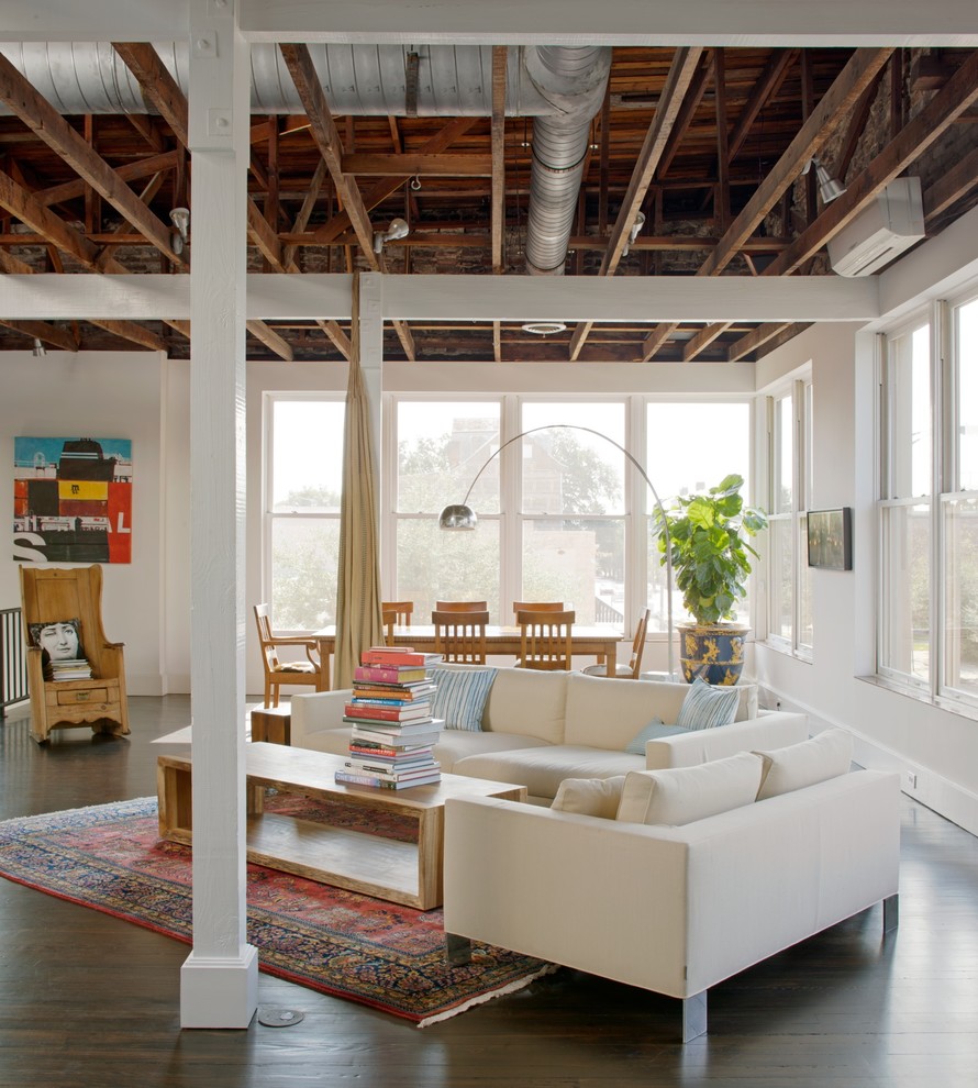 Inspiration for an industrial open concept living room in Atlanta with white walls.