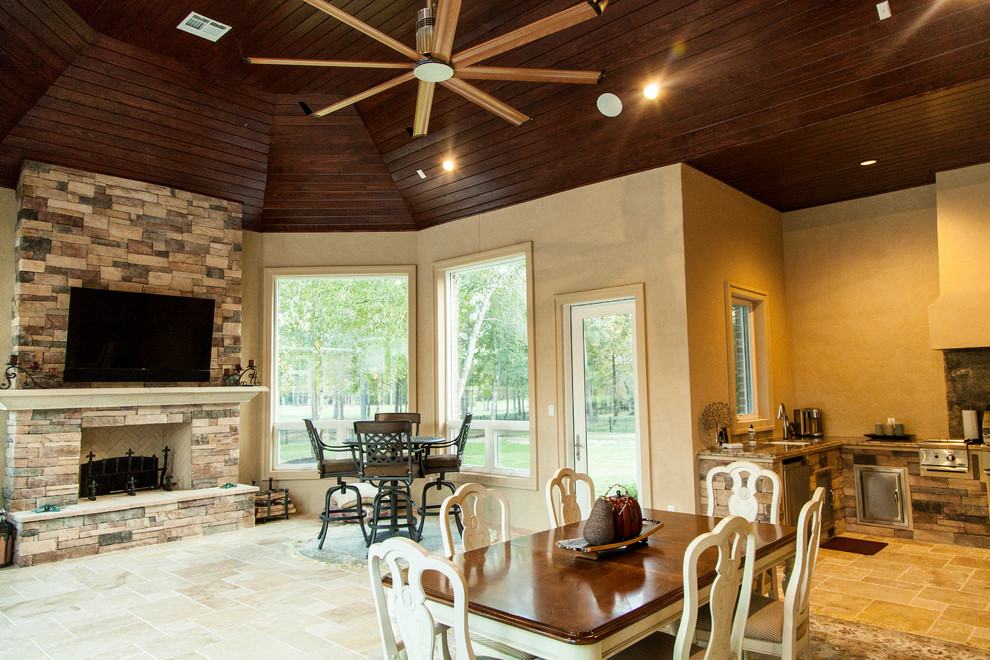 Inspiration for a large traditional sunroom in Houston with travertine floors, a standard fireplace, a stone fireplace surround and a standard ceiling.