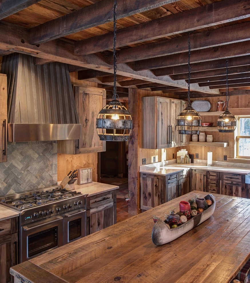 Photo of a country u-shaped eat-in kitchen in Minneapolis with a farmhouse sink, flat-panel cabinets, distressed cabinets, quartzite benchtops, stainless steel appliances, with island and timber splashback.