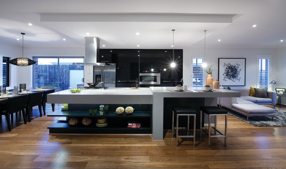 Inspiration for a mid-sized contemporary galley eat-in kitchen in Melbourne with an undermount sink, flat-panel cabinets, black cabinets, quartz benchtops, stainless steel appliances, medium hardwood floors and with island.