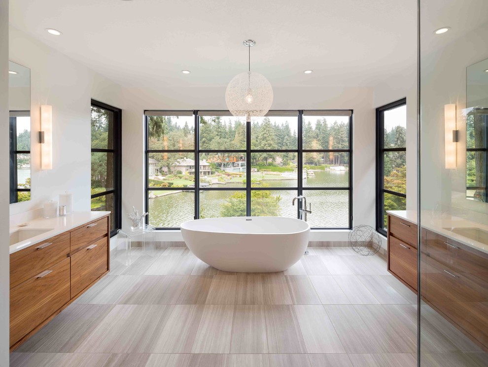 Photo of a contemporary master bathroom in Portland with medium wood cabinets and a freestanding tub.