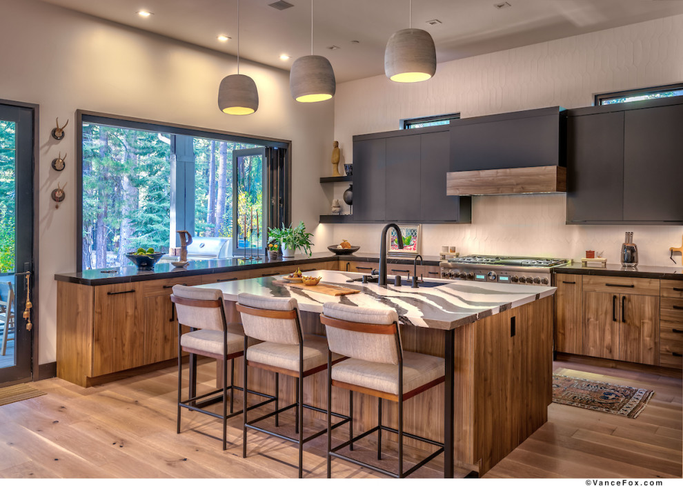 Open concept kitchen - mid-sized transitional open concept kitchen idea with flat-panel cabinets, black cabinets and an island