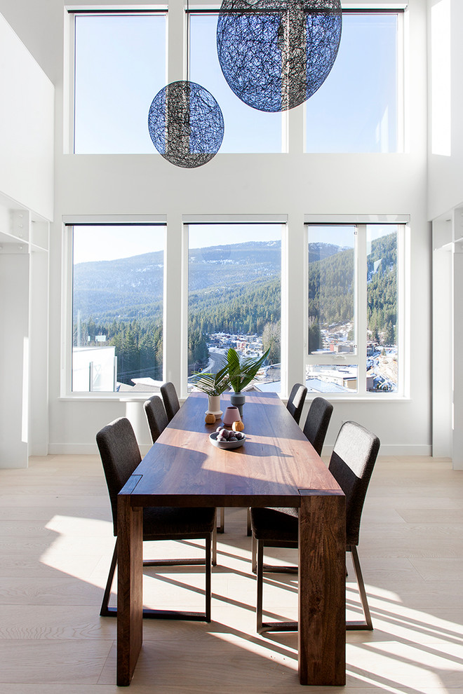 Inspiration for a large contemporary open plan dining in Vancouver with white walls and light hardwood floors.