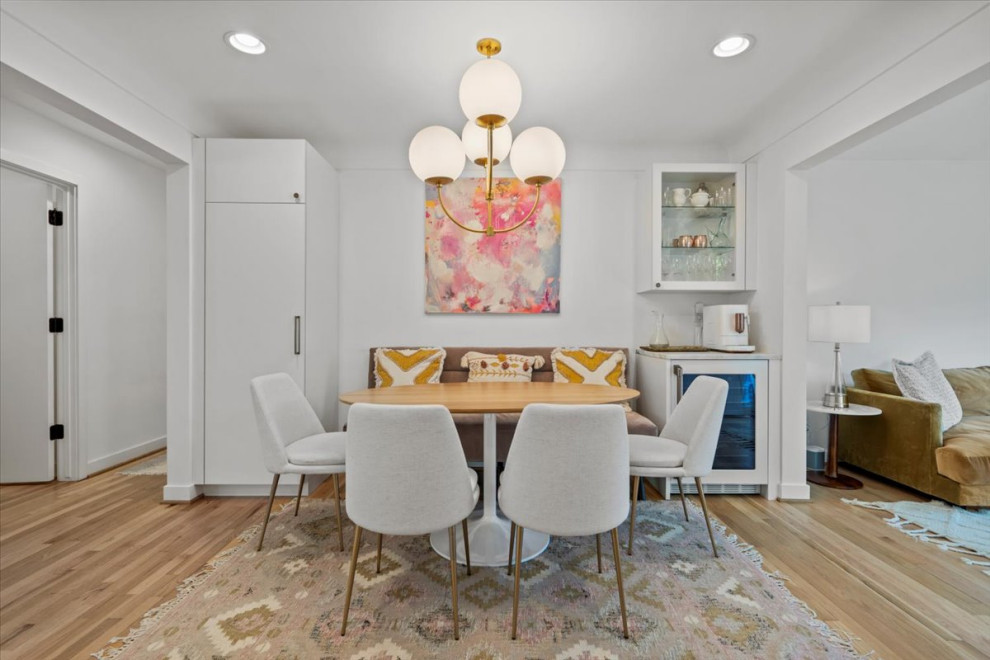 Photo of a small eclectic kitchen/dining combo in Phoenix with white walls and light hardwood floors.