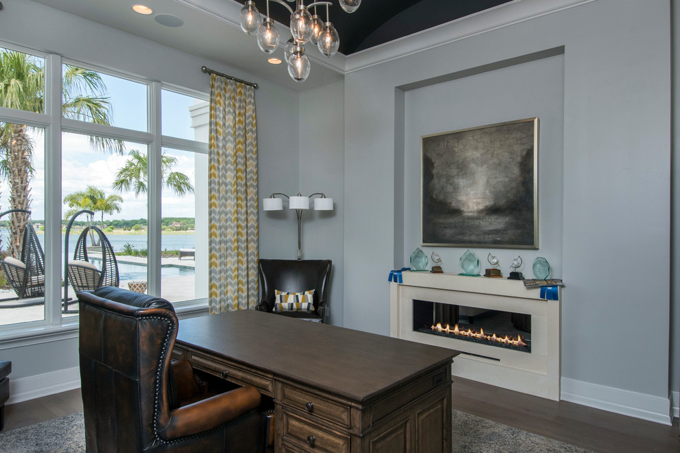 Inspiration for a mid-sized contemporary home office in Tampa with grey walls and a two-sided fireplace.