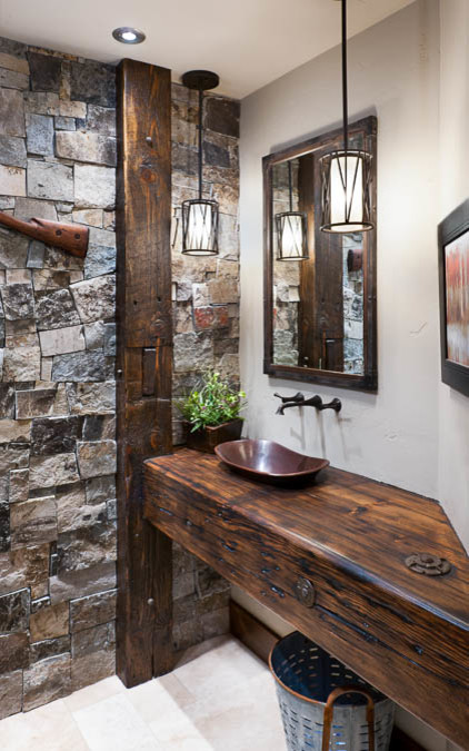 This is an example of a country bathroom in Other with a trough sink, distressed cabinets and wood benchtops.
