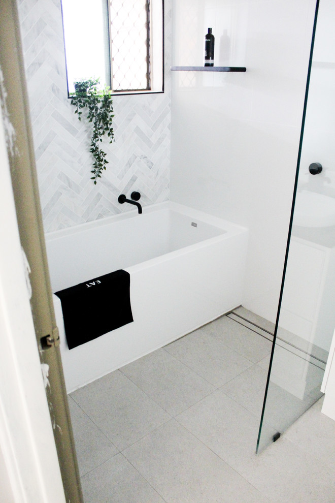 Design ideas for a small modern kids bathroom in Perth with flat-panel cabinets, white cabinets, a freestanding tub, an open shower, a one-piece toilet, white tile, ceramic tile, white walls, porcelain floors, a vessel sink, engineered quartz benchtops, grey floor, an open shower and black benchtops.