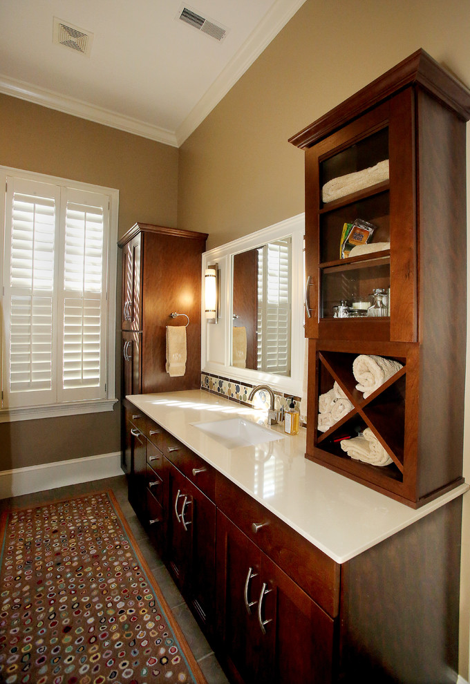 Photo of a mid-sized transitional master bathroom in Charleston with an undermount sink, shaker cabinets, dark wood cabinets, engineered quartz benchtops, beige tile, beige walls and ceramic floors.