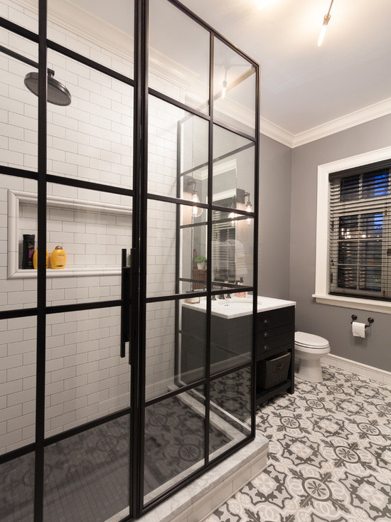 This is an example of a mid-sized transitional master bathroom in Chicago with flat-panel cabinets, black cabinets, a corner shower, a two-piece toilet, white tile, subway tile, grey walls, terra-cotta floors, an undermount sink and marble benchtops.