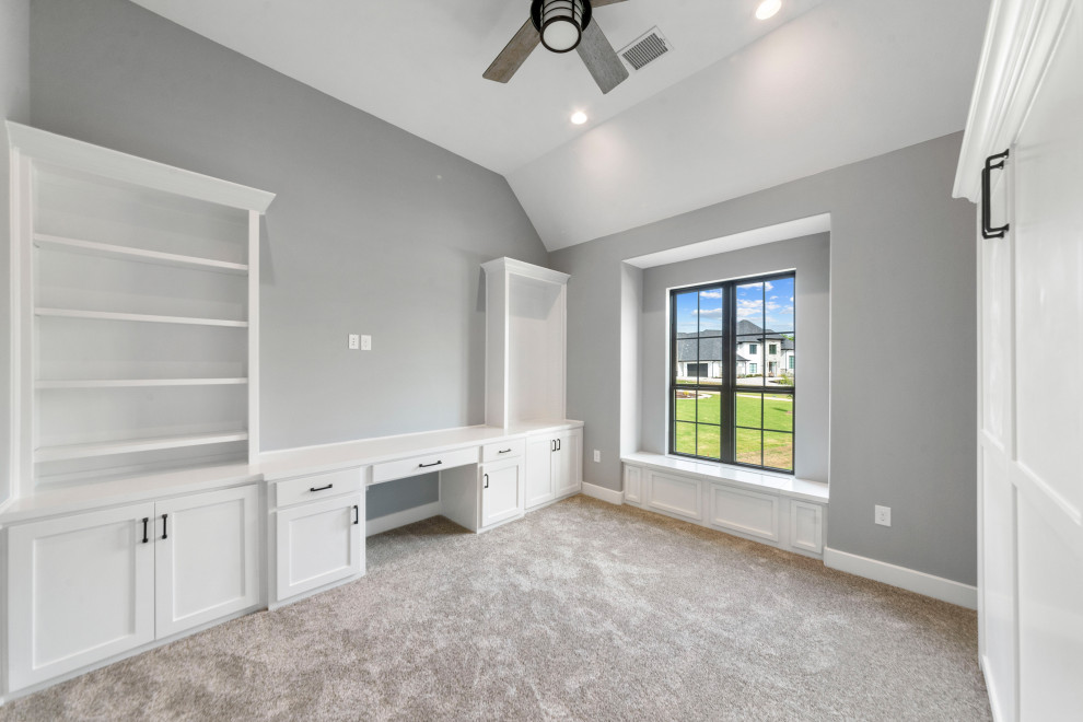 This is an example of a mid-sized contemporary study room in Dallas with grey walls, carpet, a built-in desk and grey floor.