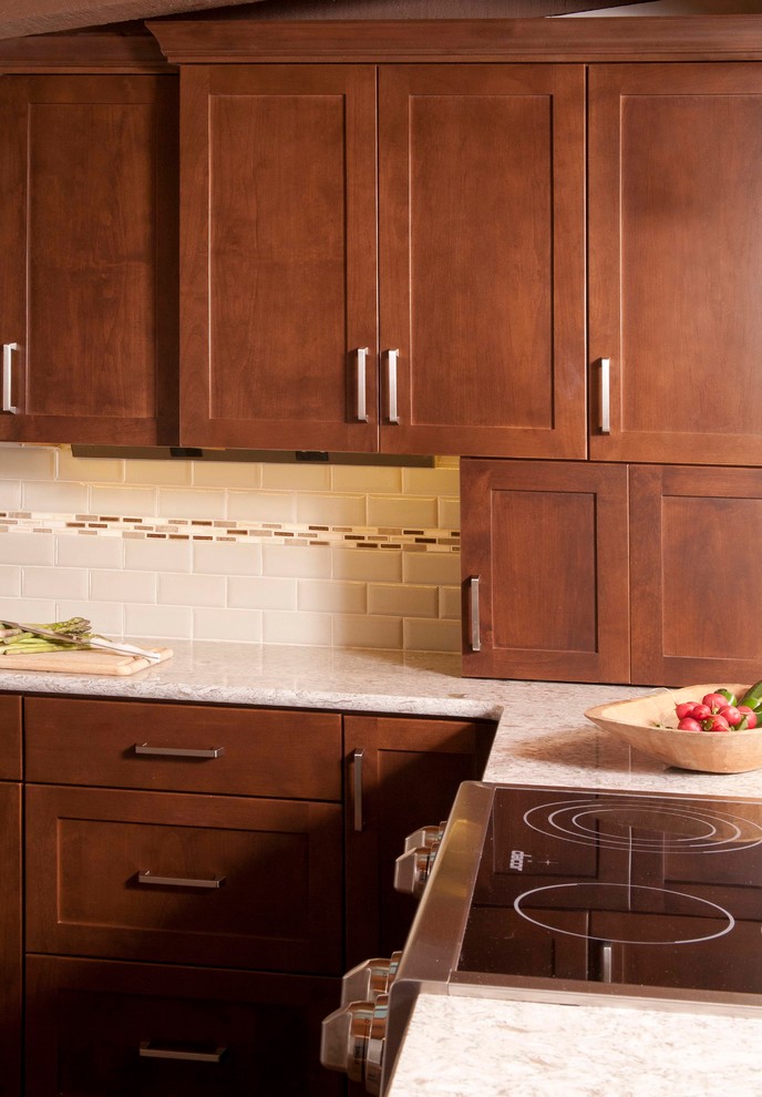 Example of a mid-sized transitional dark wood floor kitchen design in Seattle with an undermount sink, shaker cabinets, dark wood cabinets, beige backsplash, subway tile backsplash, stainless steel appliances and a peninsula