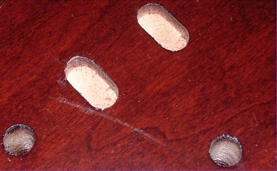 Why does maple veneer desk scratch/dent easily?