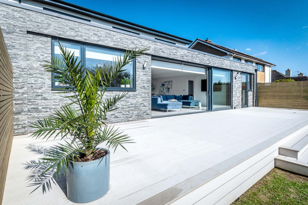 Photo of an expansive contemporary two floor rear detached house in Devon with stone cladding.