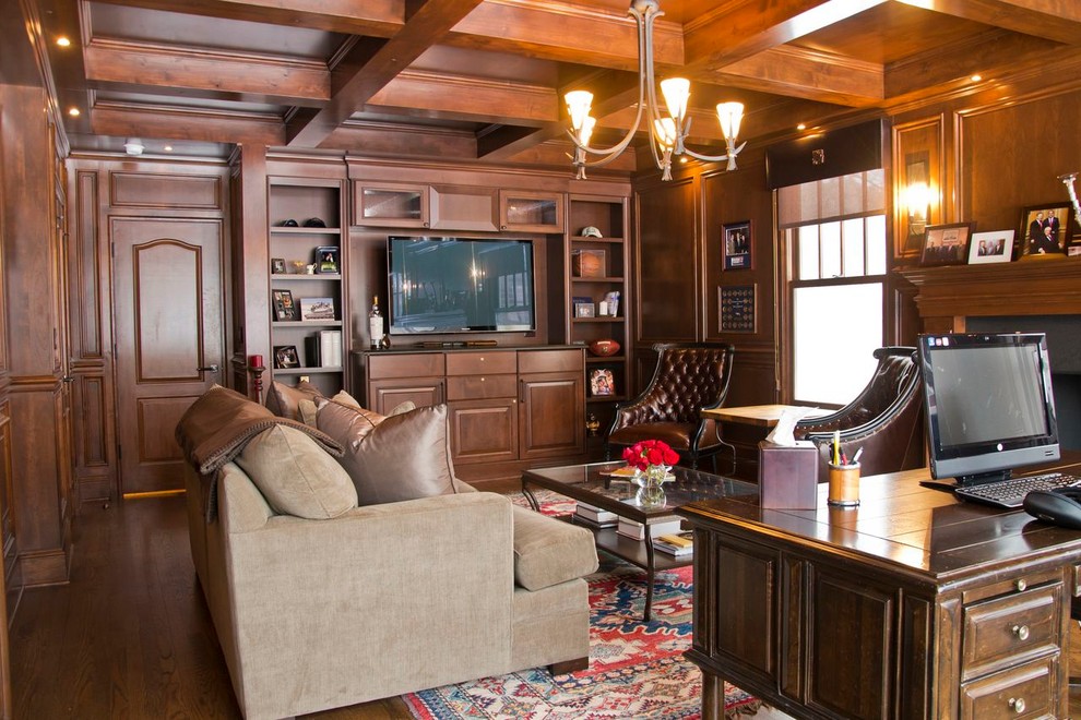 This is an example of a large traditional study room in Chicago with brown walls, medium hardwood floors, a standard fireplace and a freestanding desk.