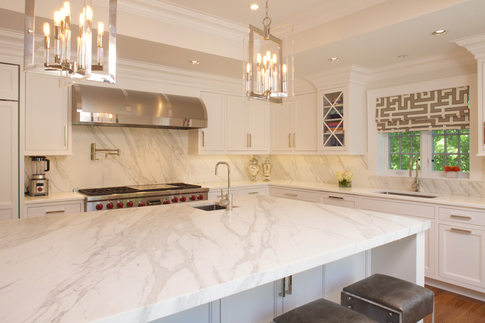 Eat-in kitchen - large transitional u-shaped medium tone wood floor eat-in kitchen idea in New York with white cabinets, marble countertops, stone slab backsplash, paneled appliances, an island, an undermount sink and recessed-panel cabinets