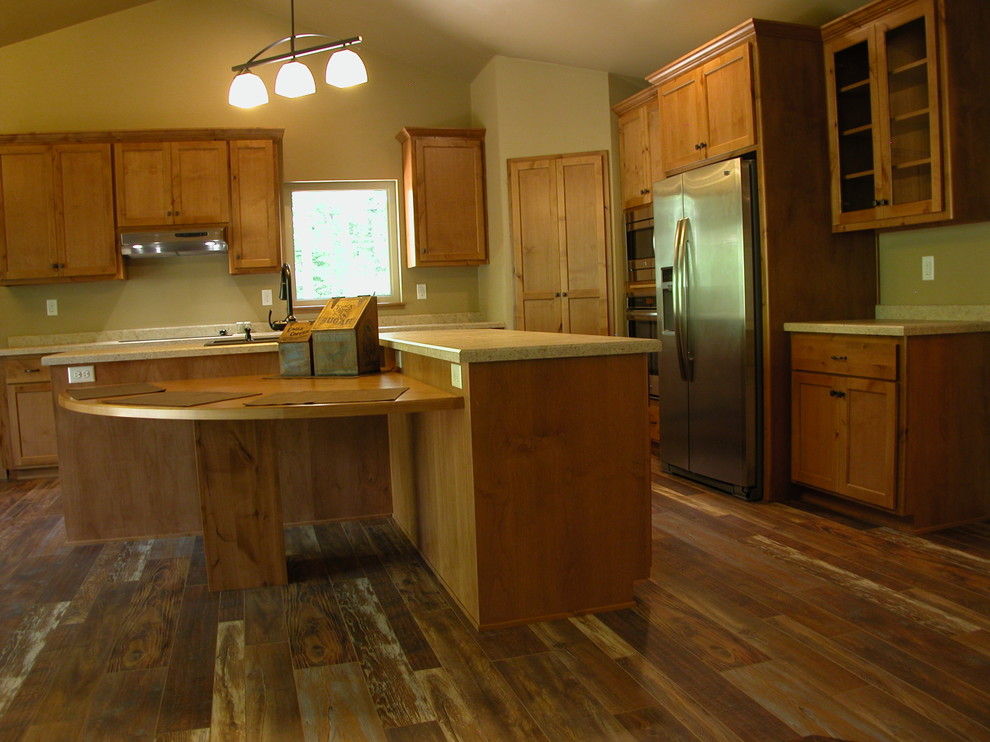 Inspiration for a rustic kitchen remodel with white cabinets, stainless steel appliances and an island