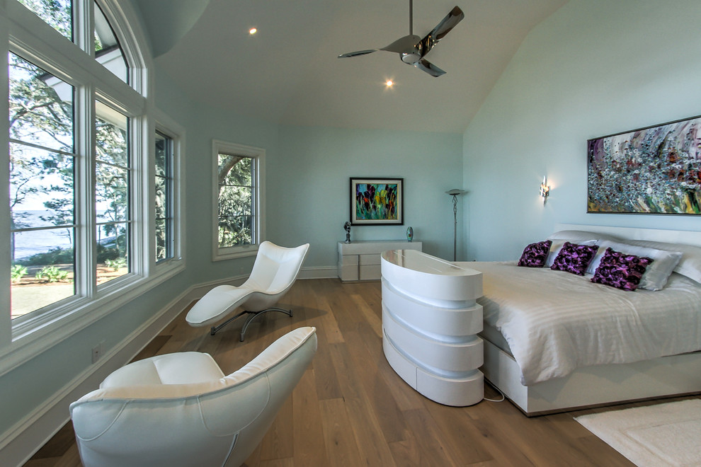 This is an example of a mid-sized transitional master bedroom in San Diego with green walls, medium hardwood floors, no fireplace and a tile fireplace surround.