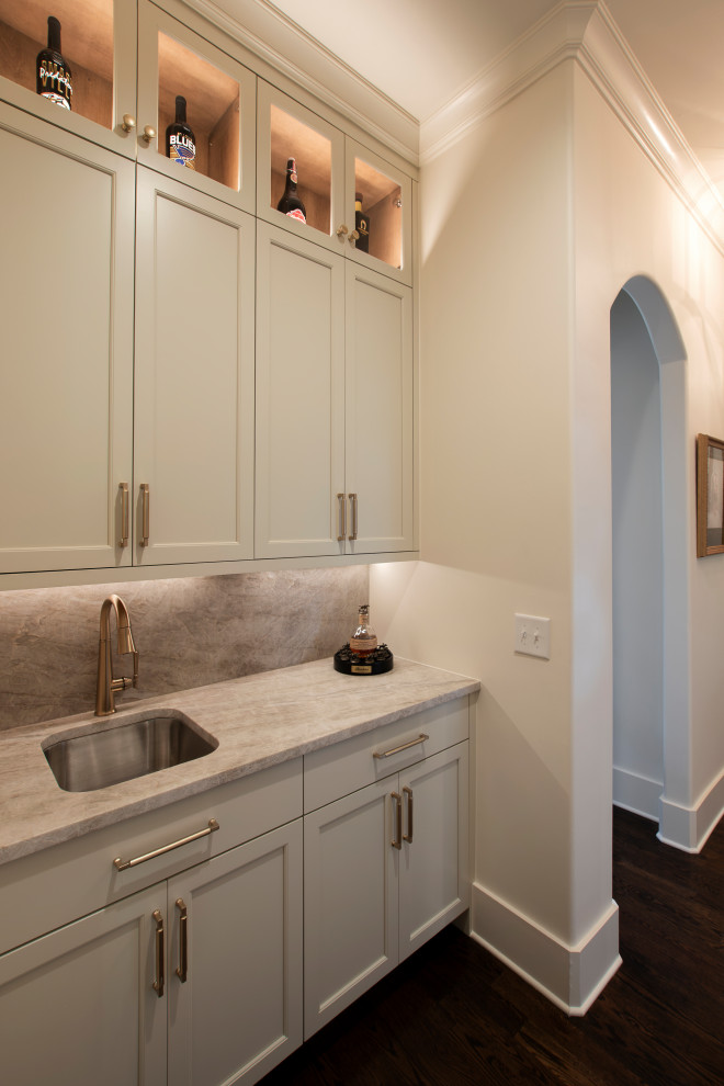 Inspiration for a large transitional l-shaped dark wood floor and brown floor open concept kitchen remodel in Nashville with an undermount sink, beaded inset cabinets, white cabinets, quartzite countertops, beige backsplash, stone slab backsplash, stainless steel appliances, an island and beige countertops