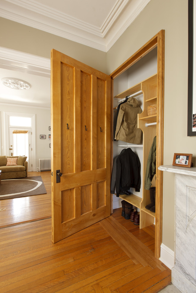 Design ideas for an eclectic gender-neutral built-in wardrobe in Providence with medium hardwood floors.