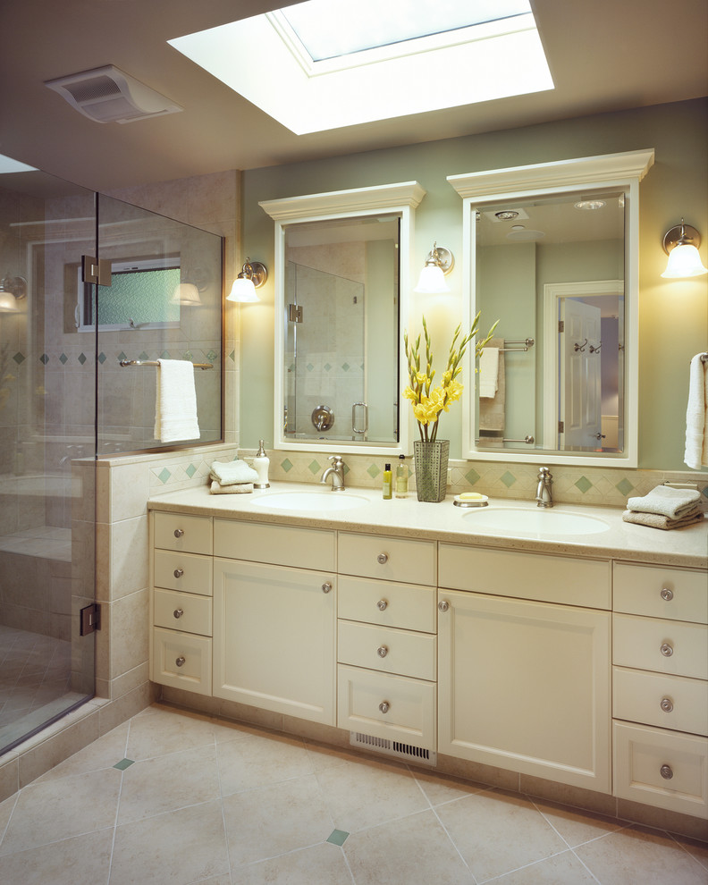 This is an example of a traditional bathroom in San Francisco with recessed-panel cabinets, white cabinets and an alcove shower.