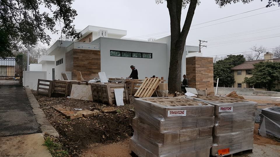 Example of a mid-sized white two-story stucco flat roof design