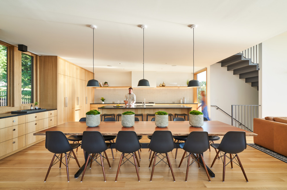 Idee per una sala da pranzo aperta verso la cucina minimalista di medie dimensioni con pavimento in legno massello medio