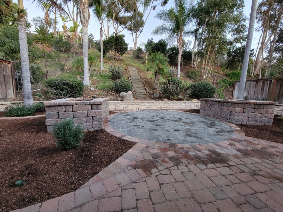 Inspiration for a mid-sized country backyard full sun xeriscape for spring in San Diego with with raised garden bed and concrete pavers.