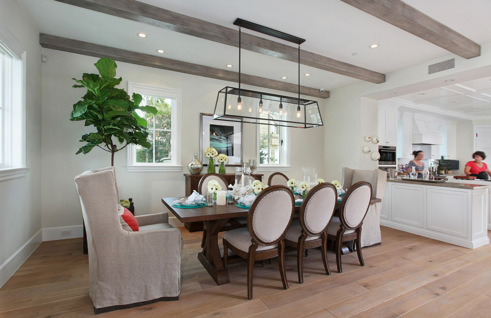 Beach style kitchen/dining combo in Orange County with white walls and light hardwood floors.