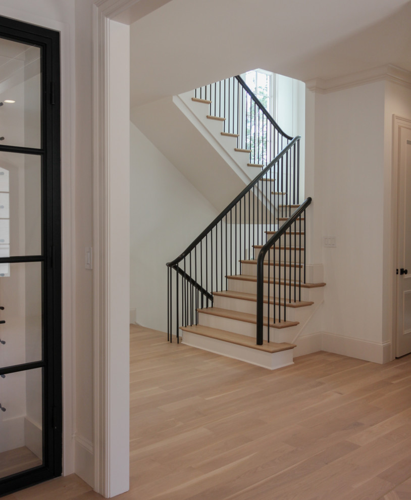 Design ideas for a large modern wood u-shaped mixed railing staircase in DC Metro with painted wood risers and wainscoting.
