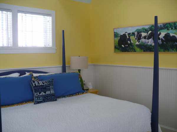 This is an example of a mid-sized transitional guest bedroom in Boston with yellow walls and carpet.