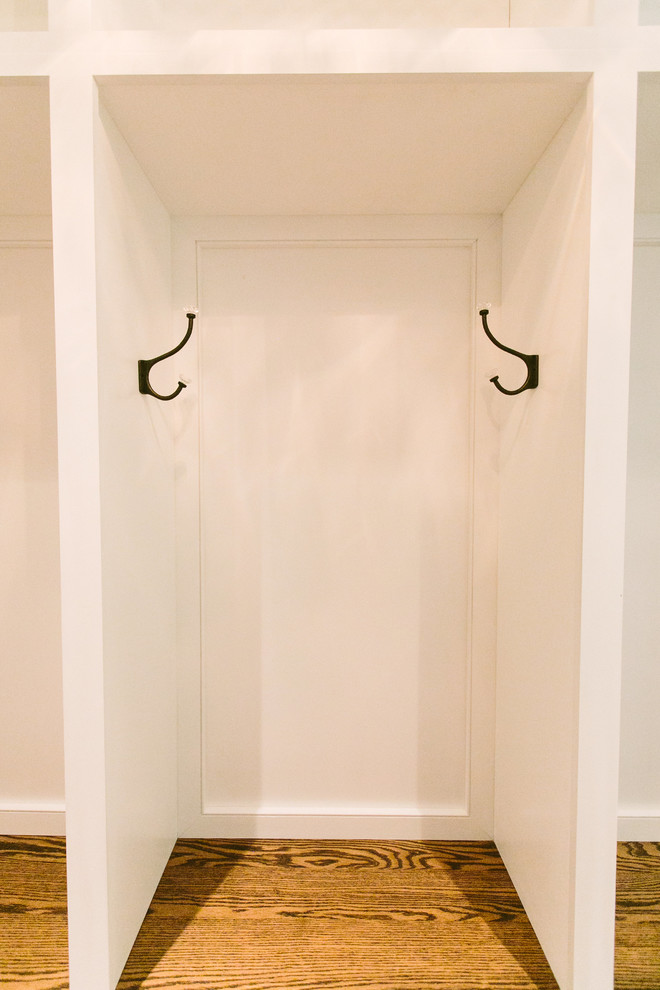 Example of a mid-sized transitional medium tone wood floor front door design in Baltimore with beige walls and a white front door