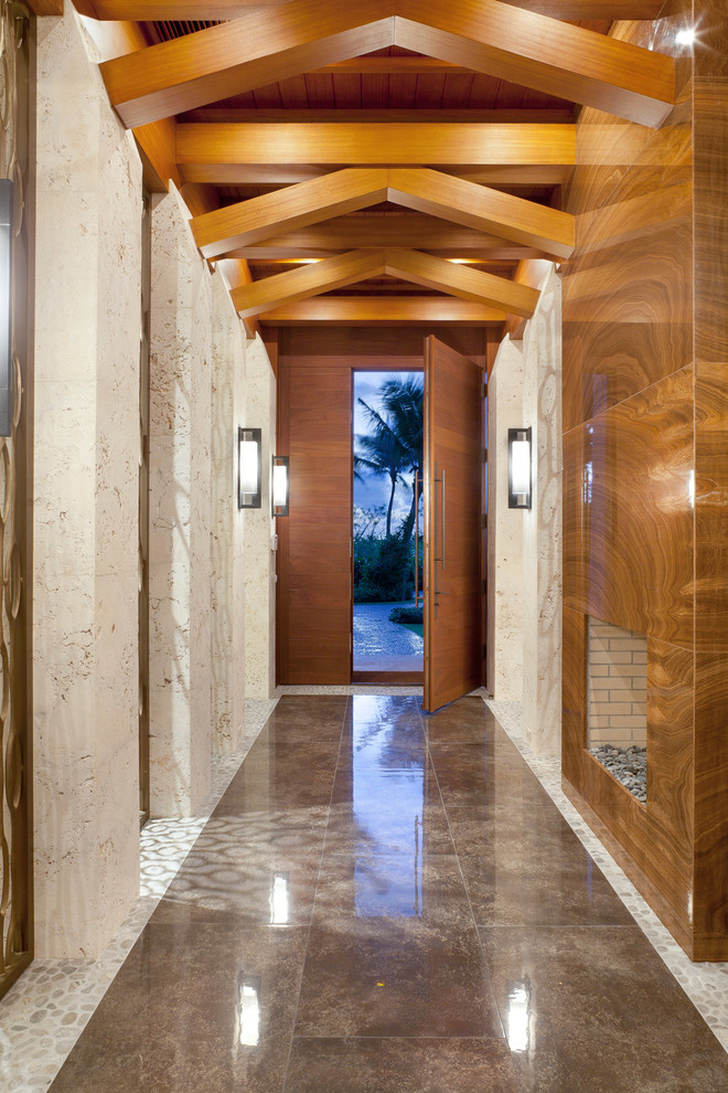 Design ideas for a contemporary entry hall in Miami with a single front door and a medium wood front door.
