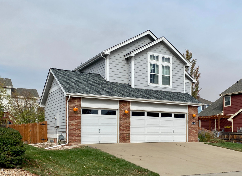 This is an example of a mid-sized traditional two-storey grey house exterior in Denver with mixed siding, a gable roof, a shingle roof and a grey roof.