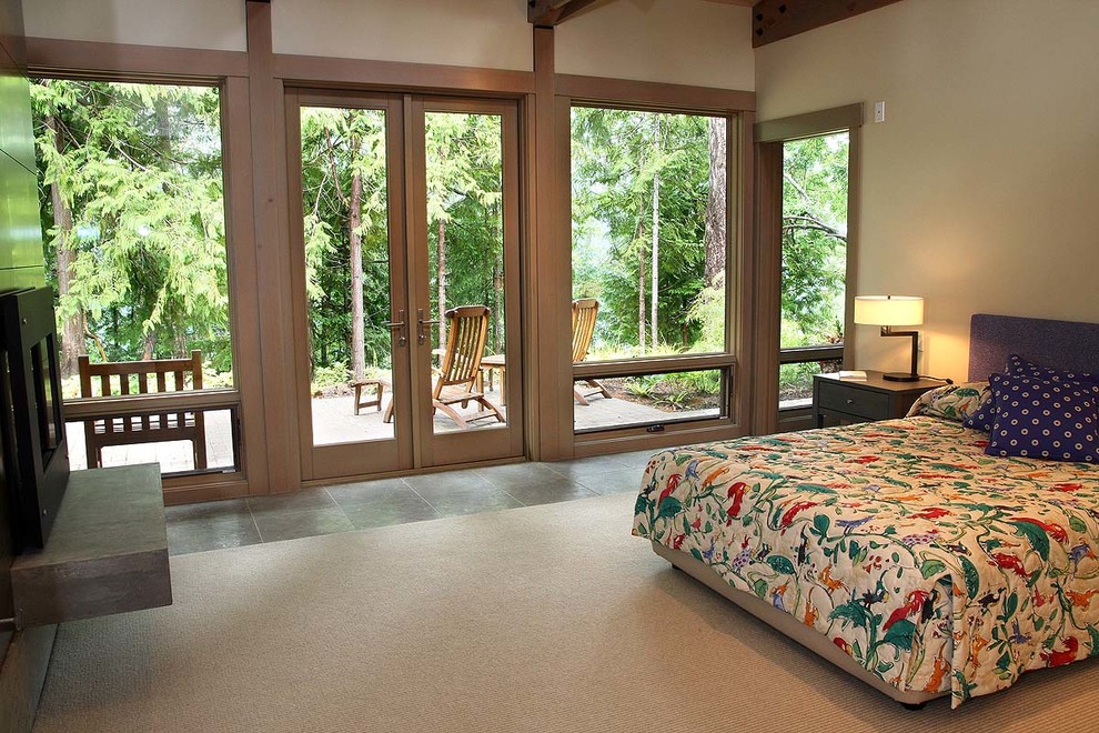 This is an example of a mid-sized traditional master bedroom in Seattle with beige walls, ceramic floors and grey floor.